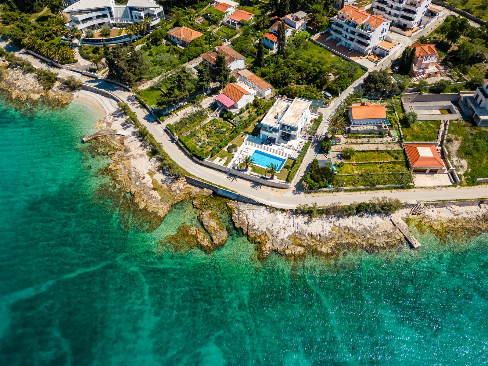 Aerial view of a private island residence, its pool and the Brač shoreline