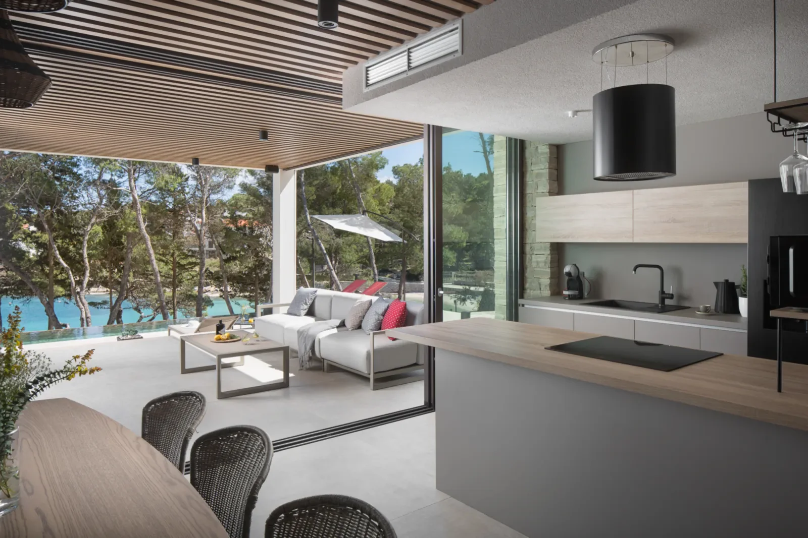 Open-plan living space at a private coastal estate opening towards the sea